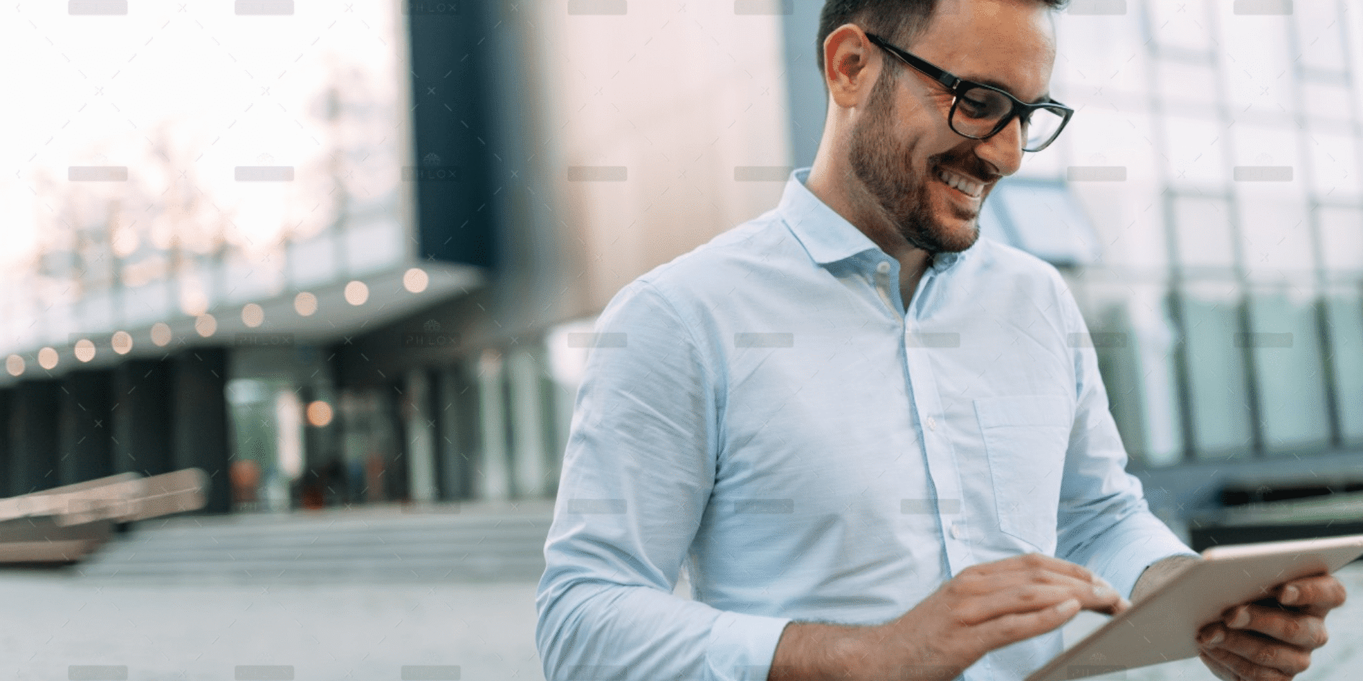 demo-attachment-59-portrait-of-businessman-in-glasses-holding-tablet-AWVHCJU